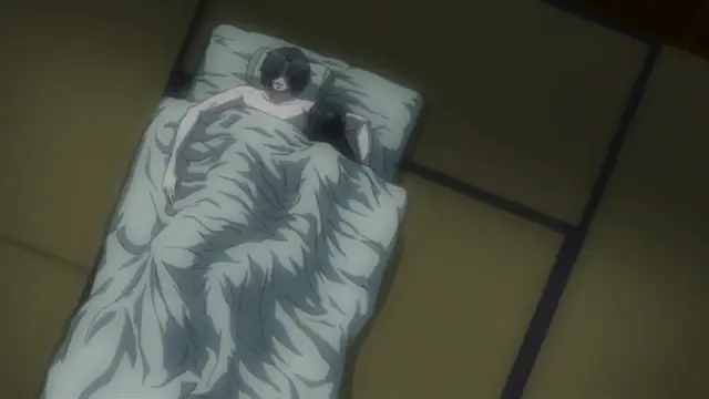 A man and a woman lie in bed together under a large duvet on a tatami mat floor in a dimly lit room. Screenshot from Kara no Shoujo - Episode 2