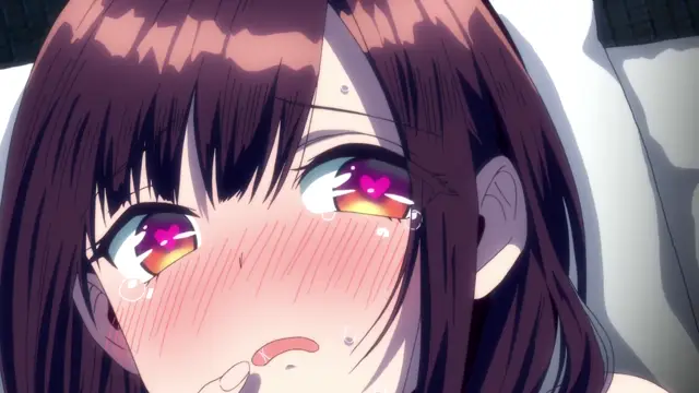 A blushing anime girl with long dark hair and heart-shaped pupils looks up with a dazed, aroused expression while lying on a bed. Screenshot from Girl's Rush - Episode 2