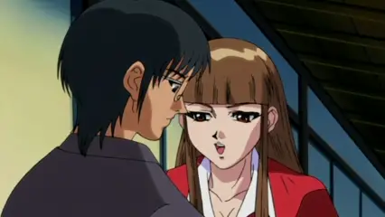 A man in a black shirt leans in close to a woman wearing a red school uniform with a white collar, who looks surprised as they stand in an indoor setting. Screenshot from Hana Dorei - Episode 1