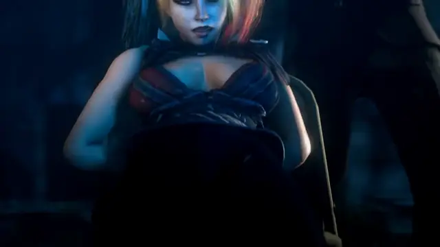 A blue-haired anime woman with a choker and dark red dress is seated in a dimly lit room, looking forward with a somber expression. Screenshot from Scarlet Nights