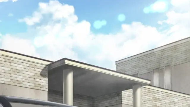 A wide-angle shot shows a modern building with a flat roof and pillars under a bright blue sky with fluffy white clouds. Screenshot from Hitozuma Mitsu to Niku - Episode 2