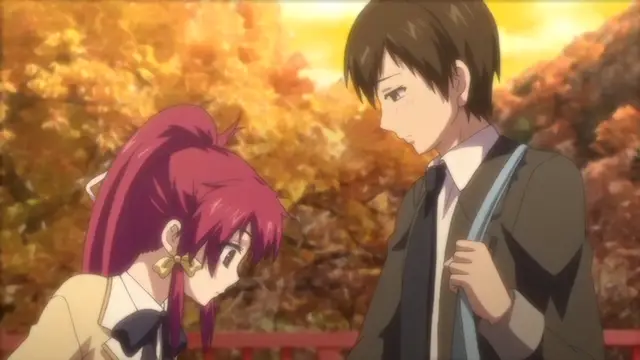 A high school girl with long pink hair and a school uniform looks down sadly while a boy with brown hair and a school uniform stands beside her in a park with autumn leaves. Screenshot from Kagirohi Shaku Kei – Another 3