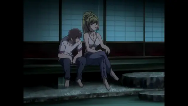 A distressed young man with brown hair leans his head on the shoulder of a blonde woman in a white tank top and blue pants as they sit together on a stone bench in a traditional Japanese-style room. Screenshot from Nee Chanto Shiyou Yo! - Episode 1