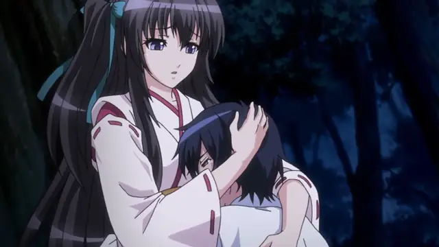 A long-haired woman in a white kimono looks down with a concerned expression while cradling an unconscious man in her arms in a dark forest. Screenshot from Kotowari - Episode 2