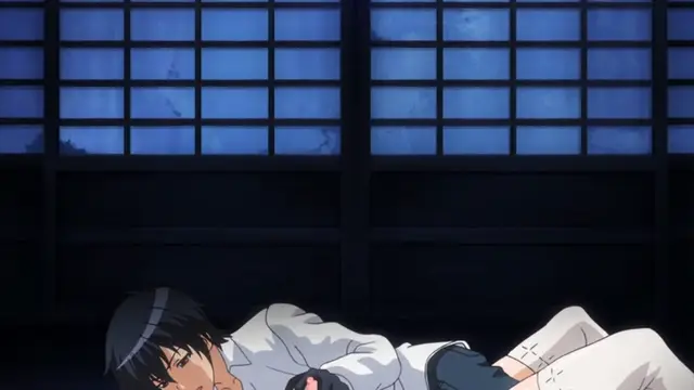 A man with black hair and a headband lies on a tatami mat in a traditional Japanese room with shoji doors in the background, looking exhausted or dazed. Screenshot from Kotowari - Episode 2
