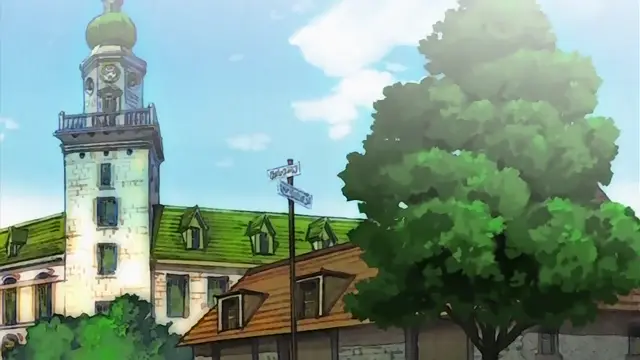An anime-style landscape shows a European-inspired town square with a prominent clock tower building and lush green trees under a bright blue sky. Screenshot from Himekishi Lilia - Episode 6