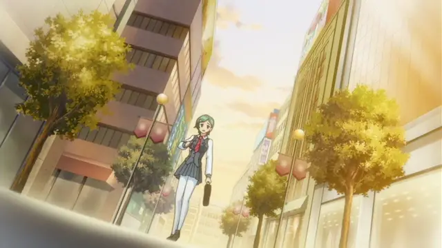 An anime girl with green hair and a school uniform stands on a city sidewalk between buildings with autumn trees. Screenshot from Kansen Inyoku no Rensa - Episode 2