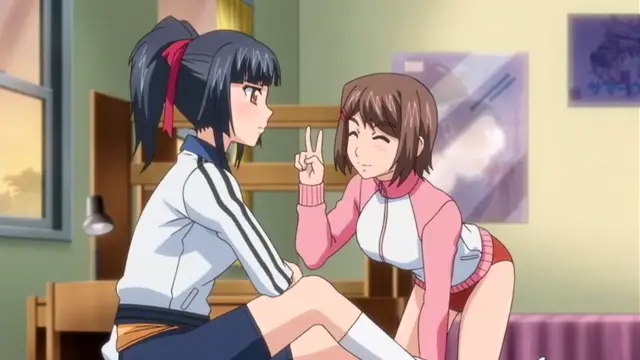 In an indoor setting, a girl with dark hair tied in a ponytail sits on a chair wearing a white and blue athletic tracksuit, looking surprised as another girl with brown hair, wearing a pink jacket and red shorts, leans in and makes a peace sign while winking. Screenshot from Last Waltz - Episode 1