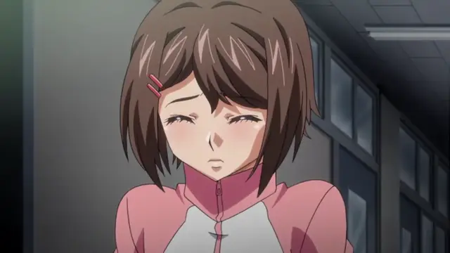 A blushing, wide-eyed anime girl with short brown hair and a pink and white outfit looks surprised or embarrassed in a school hallway. Screenshot from Last Waltz - Episode 2