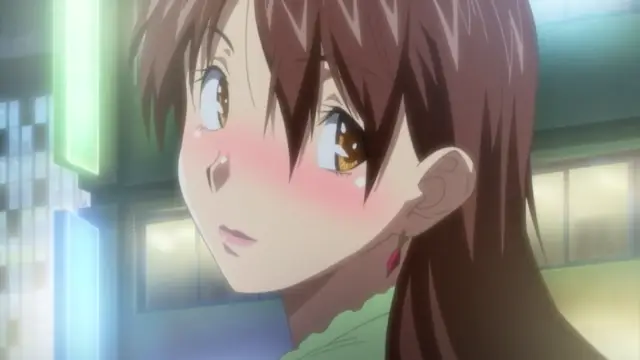 A blushing anime girl with brown hair looks to the side with a startled expression, her face flushed pink as she stands in a brightly lit outdoor city street at night. Screenshot from Harem Time - Episode 1