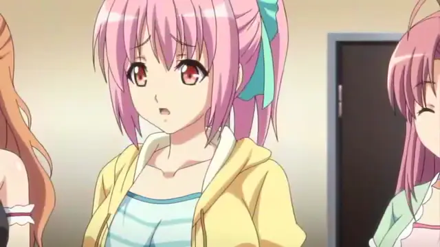 An anime girl with pink twin tails and a shocked expression stands between two other girls, wearing a yellow hoodie over a blue striped top. Screenshot from Tropical Kiss - Episode 3