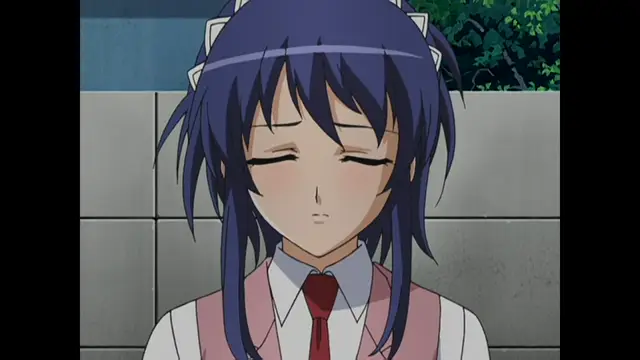 An anime girl with long purple hair and a school uniform stands with her eyes closed and a blushing face. Screenshot from Cafe Junkie - Episode 1