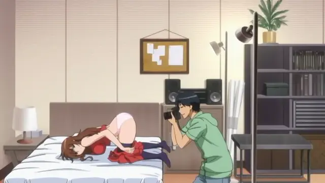 A man in a green shirt uses a camera to take a photo of a woman in a red dress and white underwear who is lying face down on a bed in a bedroom. Screenshot from Joshikousei no Koshitsuki - Episode 3