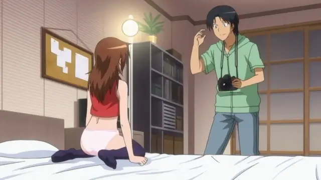 A woman in a red top and pink panties sits on a bed while a man with a camera stands before her, smiling and gesturing toward her body. Screenshot from Joshikousei no Koshitsuki - Episode 3
