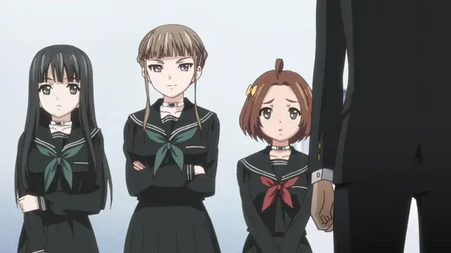 Three high school girls in black sailor-style school uniforms with large red and green scarves stand in a line, looking towards a tall man in a black suit standing on the right side of the frame. Screenshot from Euphoria - Episode 1