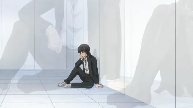 A young man with black hair sits on a tiled floor in a white room, looking distressed while surrounded by the looming shadows of several large, standing figures. Screenshot from Euphoria - Episode 3