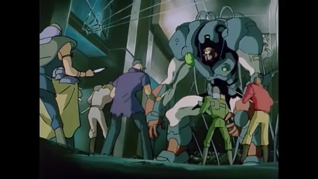 A giant, blue and black robotic suit stands in a hangar, towering over several people, including a man in a purple shirt and a woman in a green outfit. Screenshot from Imma Youjo: The Erotic Temptress - Episode 1