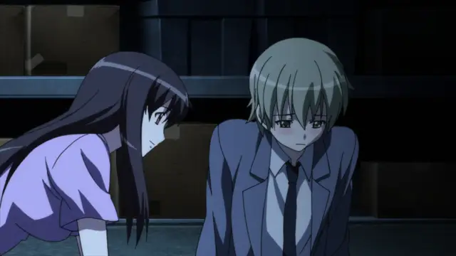 A shocked and blushing young man in a school uniform stands next to a girl with long black hair in a purple dress as they appear to be in a dark storage room or classroom. Screenshot from Aki Sora: In a Dream - Episode 1
