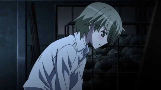 A girl with short green hair and a light blue shirt stands in a dimly lit room, looking down at a large pile of dark objects behind a metal cage. Screenshot from Aki Sora: In a Dream - Episode 1