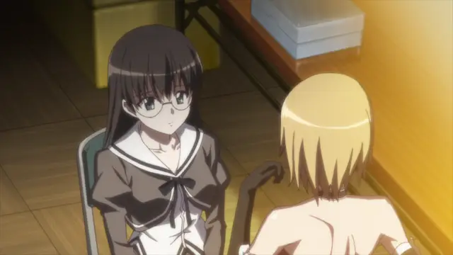 A black-haired girl in a school uniform with glasses looks on as she sits next to a blonde girl who is topless. Screenshot from Aki Sora: In a Dream - Episode 1