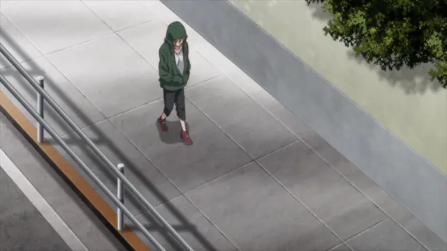 A high-angle, wide shot shows a girl in a green hoodie standing alone on a train platform next to a railing. Screenshot from Aki Sora: In a Dream - Episode 2