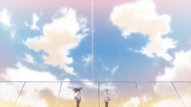 Two anime girls stand on a school sports ground behind a fence under a bright blue sky with fluffy white clouds. Screenshot from Aki Sora: In a Dream - Episode 2
