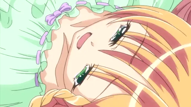 A close-up anime shot of a blonde girl with green eyes lying down on a light green ruffled pillow, looking up with a distressed or pleading expression. Screenshot from Oshiete Re Maid - Episode 1
