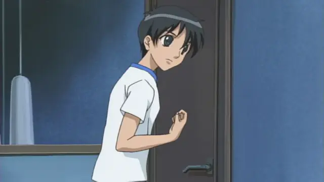 A young woman with dark hair and large eyes, wearing a white t-shirt with a blue collar, stands nervously in a doorway looking into a room. Screenshot from Anejiru The Animation - Episode 1