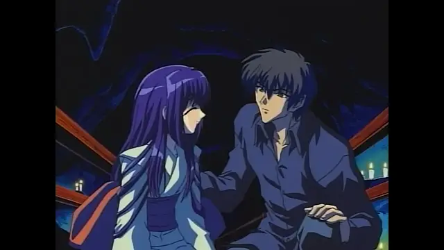 A young man with dark hair leans in close to a woman with long purple hair, his hand resting on her shoulder as they look at each other intently in a dimly lit room with candles in the background. Screenshot from Moonlight Lady - Episode 4