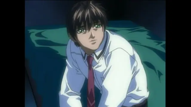 A young man with dark hair and green eyes, wearing a school uniform with a red tie, sits on a bed with a green blanket while looking forward with a blank expression. Screenshot from Bible Black - Episode 4