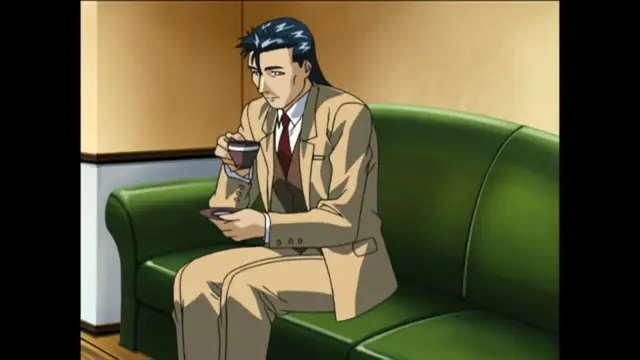 A man with dark blue hair wearing a tan suit and a red tie sits on a green sofa, holding a cup of coffee and a smartphone. Screenshot from Bible Black New Testament - Episode 2