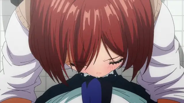 A blushing girl with short red hair and a blue bow collar is being held from behind by a person whose arms are wrapped around her shoulders. Screenshot from Yamitsuki Pheromone - Episode 1