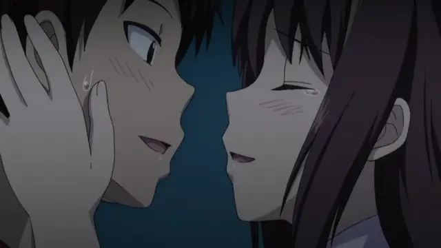 A blush-faced anime girl leans in close to a boy's face, holding his cheek with her hand as they share a playful, intimate moment. Screenshot from Koiito Kinenbi - Episode 2