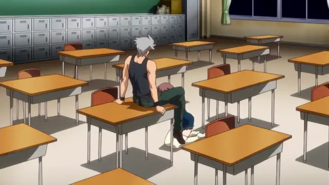 A silver-haired anime man in a black tank top and green pants sits on a school desk in a classroom, looking down at a person slumped over on the floor in front of him. Screenshot from Diabolus Kikoku - Episode 2
