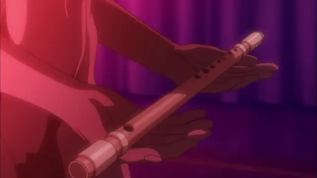 A close-up shot shows a character in a red garment holding a flute horizontally with both hands against a purple curtain backdrop. Screenshot from Witch of Steel Annerose - Episode 1