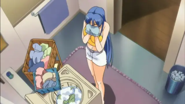 An anime girl with long blue hair and a white towel wrapped around her chest stands in a bathroom next to a washing machine, holding a cloth to her face. Screenshot from Mama Puri!? - Episode 1