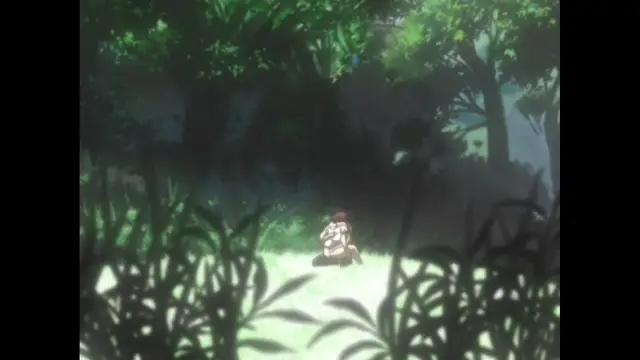 A woman with dark hair and a white top sits on a grassy field in a dense forest, looking towards the camera. Screenshot from Cambrian - Episode 1