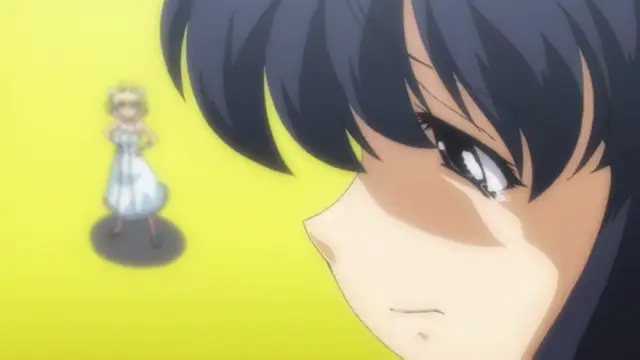 A close-up shot shows a blushing anime girl with dark hair looking down in distress or embarrassment as a smaller, blonde girl in a white dress stands in the background against a solid yellow backdrop. Screenshot from Alignment You! You! - Episode 2