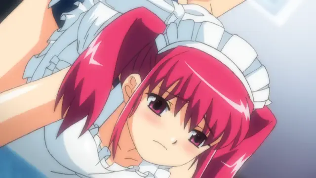 A blushing anime girl with pink hair wearing a white maid outfit is lying face down on a bed with her arms pinned back over her head. Screenshot from Tsundere Inran Shoujo Sukumi - Episode 2