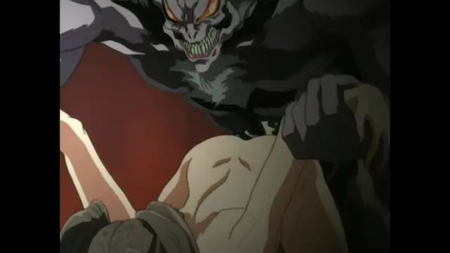A muscular, monstrous dark creature with glowing orange eyes and sharp green teeth looms over a shirtless man who is kneeling or lying on the ground. Screenshot from Guren - Crimson Lotus - Episode 1