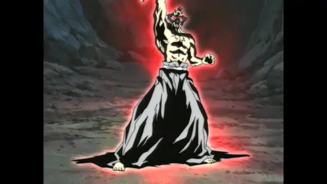 A shirtless, muscular demon man with horns and a long black skirt stands in a rocky cavern, surrounded by a glowing red aura. Screenshot from Guren - Crimson Lotus - Episode 2