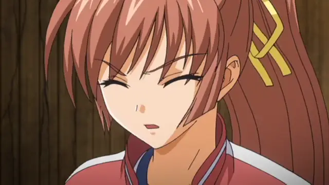 A close-up shot of a brown-haired anime girl with red eyes looking annoyed or displeased. Screenshot from Grope: Yami no naka no Kotoritachi - Episode 2