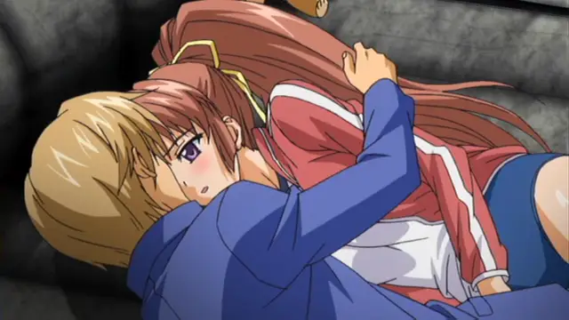 A blonde girl in a blue hoodie embraces a brown-haired girl in a red track jacket and blue shorts from behind, while both lie on a dark sofa. Screenshot from Grope: Yami no naka no Kotoritachi - Episode 2