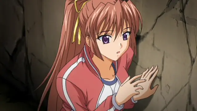 A brown-haired anime girl in a red and white tracksuit looks surprised in a cave-like setting with her hands held up. Screenshot from Grope: Yami no naka no Kotoritachi - Episode 2
