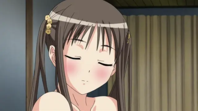 A close-up anime girl with brown hair and gold hair accessories has her eyes closed and a blushing face. Screenshot from Fault!! - Episode 2