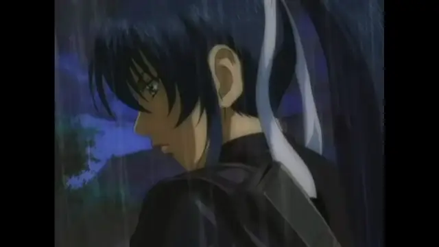 A young man with blue hair and a sword strapped to his back stands in the rain, looking down with a somber expression. Screenshot from The Last Kunoichi - Episode 1