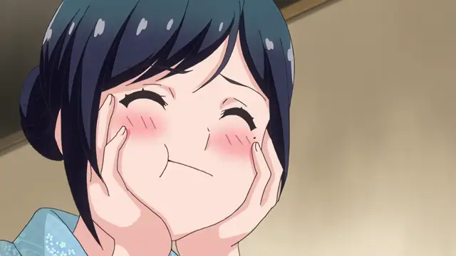 A blushing anime girl with dark hair tied in a bun smiles sheepishly with her hands on her cheeks. Screenshot from Kimi ga Suki - Episode 1