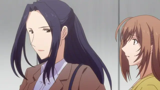 A dark-haired woman in a suit stands next to a brown-haired girl with an uneasy expression in a minimalist indoor setting. Screenshot from Eternity: Shin`ya no Nurekoi Channel - Episode 1