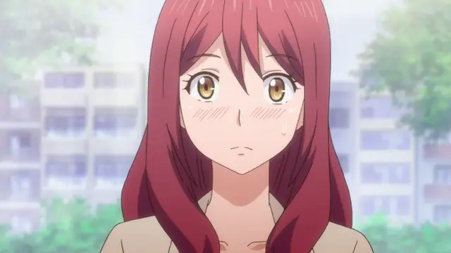 A red-haired anime girl with a worried expression looks forward with blushing cheeks and sweating brows against a blurred outdoor background of buildings and trees. Screenshot from Eternity: Shin`ya no Nurekoi Channel - Episode 3