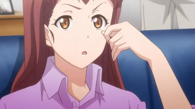 A brown-haired anime girl with a surprised expression sits on a blue sofa, resting her chin on her hand while wearing a purple collared shirt. Screenshot from Eternity: Shin`ya no Nurekoi Channel - Episode 6